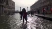 Tourists wade through high water in Venice as storms hit Italy