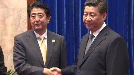 Frosty greeting between Xi and Abe