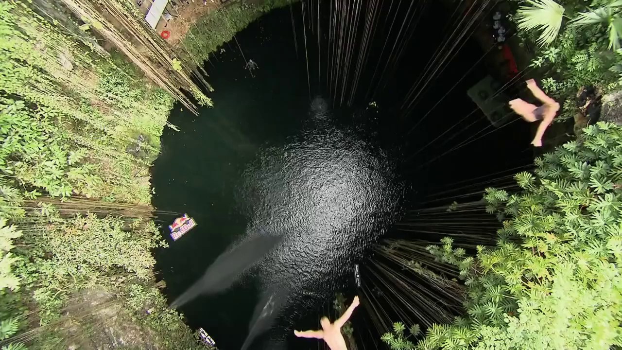 Group Cliff Dive into the Ik Kil Cenote in Yucatan mexico