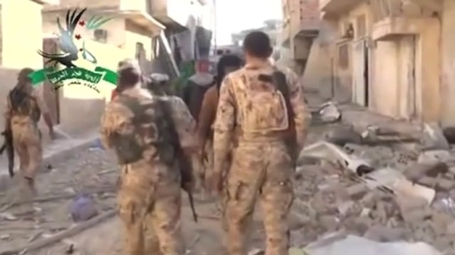 Kurdish and Syrian rebel forces tour liberated Kobani neighborhood