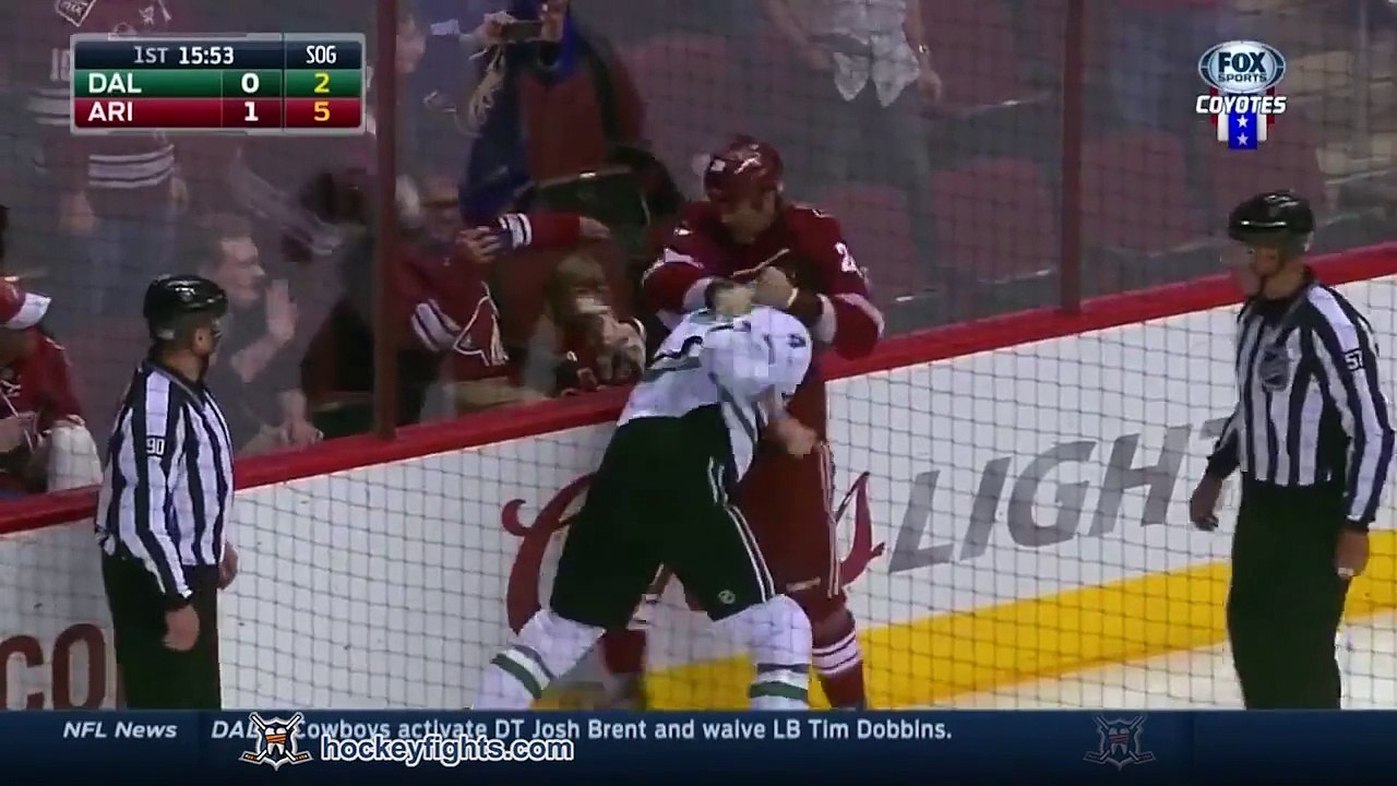 Parents shield the eyes of a little girl during brutal NHL fight