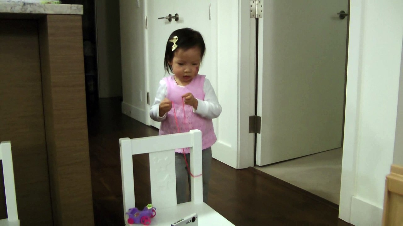 Girl Trying To Tie With A String