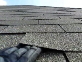 Home Inspectors Dallas Shows Loose Shingle Tabs