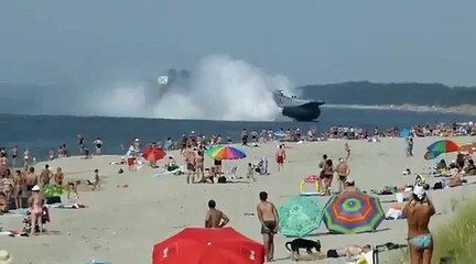Military Hovercraft Lands On Busy Beach