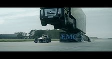 Un camion saute au dessus d'une F1 qui roule