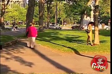 Funny woman peeing in public park.