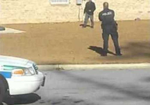 Friendly Police Officer Plays Football With Young Boy
