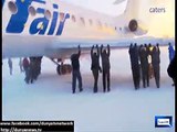 Dunya news-Russian passengers help push plane stuck in ice