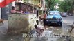 An Indian man enjoys a bath from a road In Kolkata West Bengal