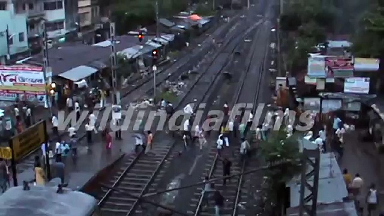 In third world country the men and women crosses the railway track by taking life in his mouth.