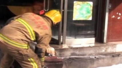 Firefighters pull out flaming gas cylinders from restaurant
