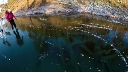 Ice skating on a clear lake crystal in Sweden - Creative