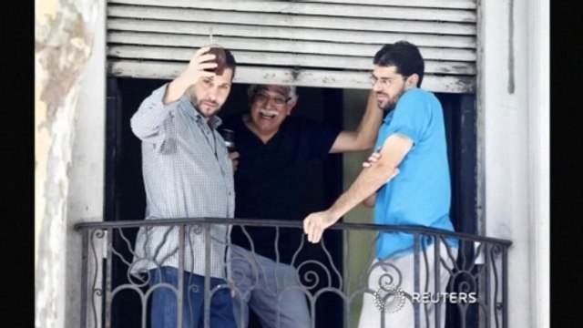 Two released Guantanamo prisoners raise a glass in Montevideo