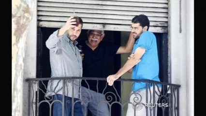 Two released Guantanamo prisoners raise a glass in Montevideo