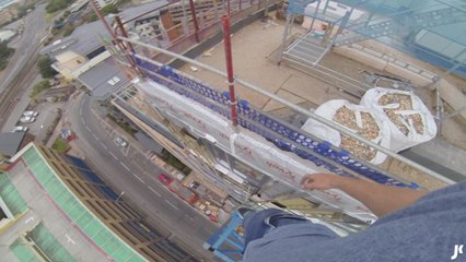 Daredevil climbs on top of crane without harness