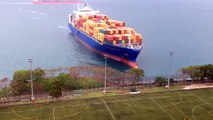 Container ship sails straight to shore by university football field