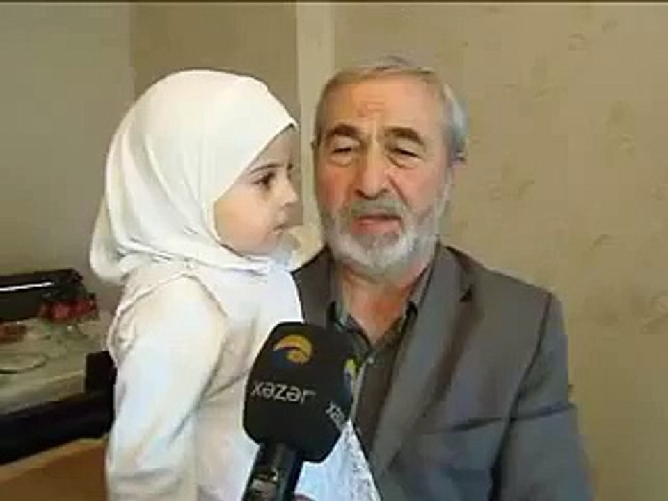 a little girl reciting holy quran