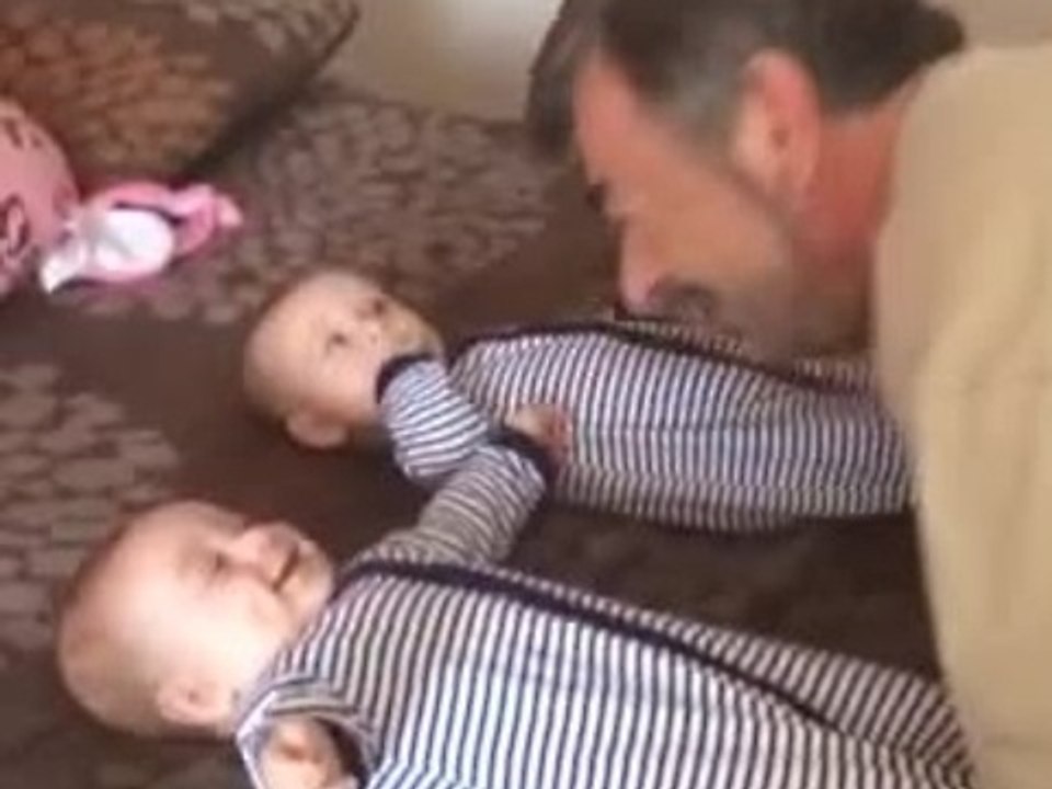 Grandpa makes twins laugh simultaneously