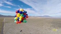 Guy in a lawn chair gets lifted by giant balloons like in the movie Up