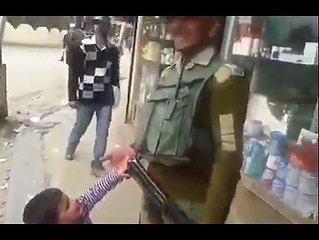 kid wants the gun of Pakistan army person.