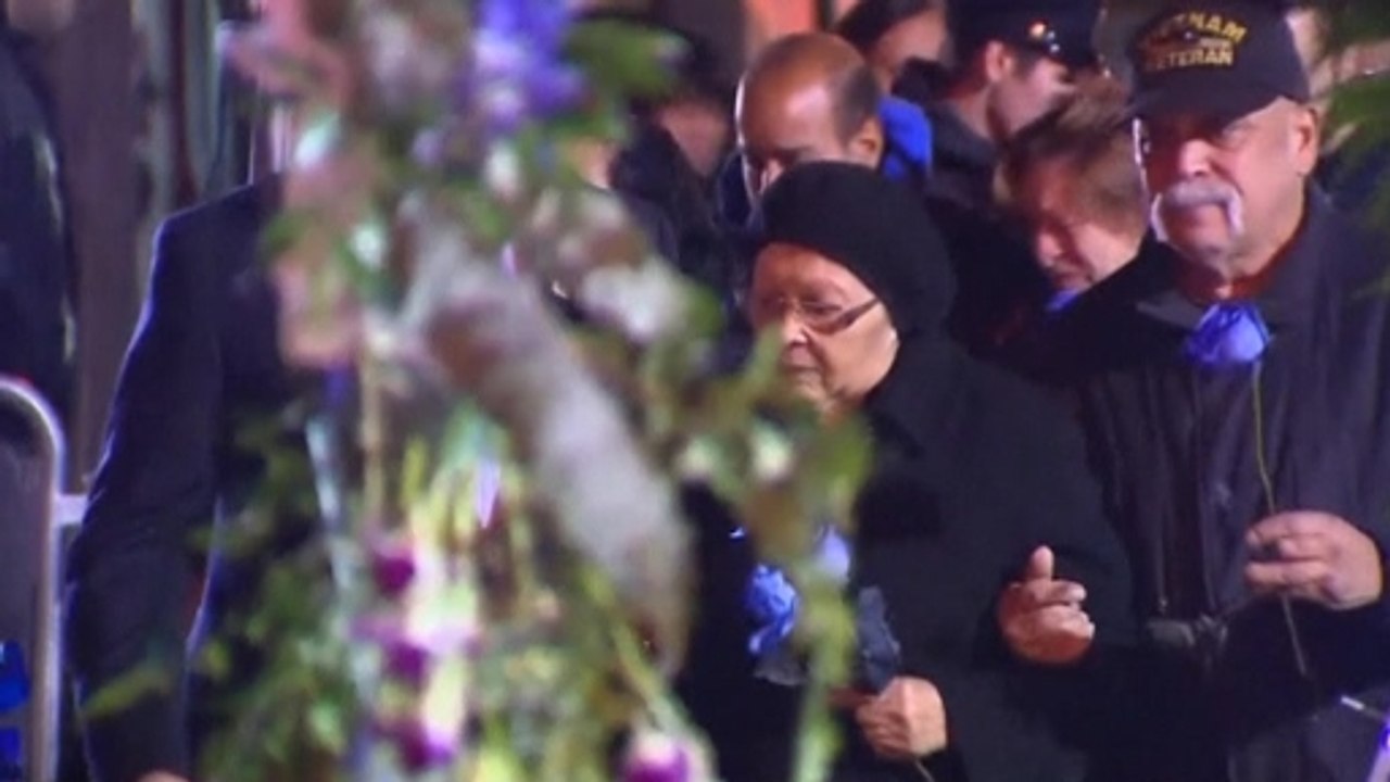 Rows of blue roses at vigil for slain NYPD officers