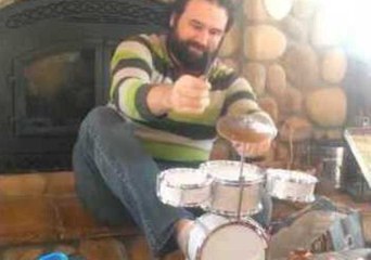 Musician Unleashes Epic Performance on Tiny Drum Set