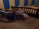 Talented young boy plays the drums perfectly