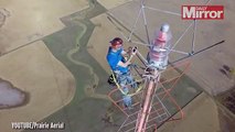 Amazing videoshows daredevil scale 1500ft aerialto change a light bulb