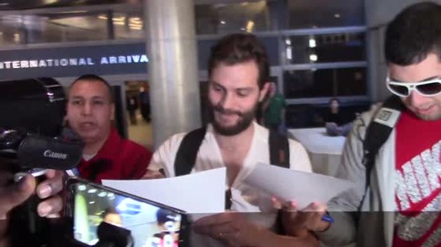 Jamie Dornan Gets Mobbed at Los Angeles Airport, Gets Asked About His 'Grapes'