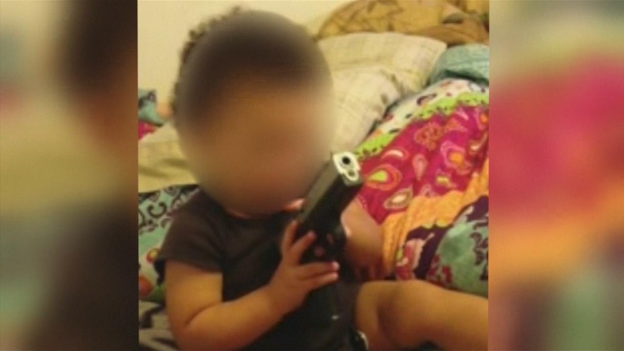 Police Investigating Dumb Parents Who Filmed Baby With Gun in Mouth