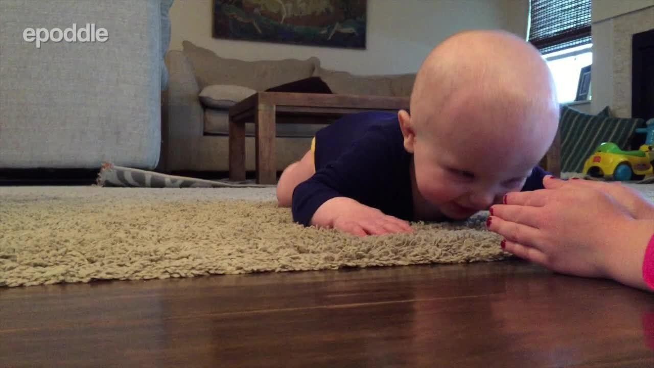 Baby laughs hysterically at rolling ping pong ball