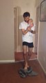 Funny dad putting pants while holding his baby : hilarious!