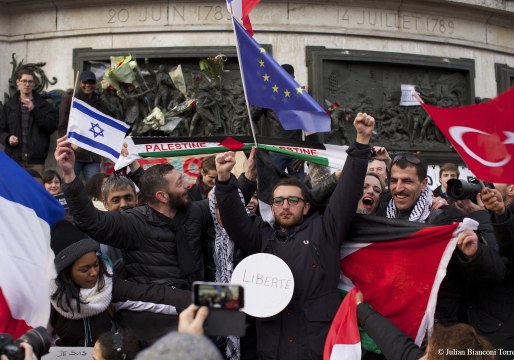 Men Carrying Israeli and Palestinian Flags Embrace in Paris