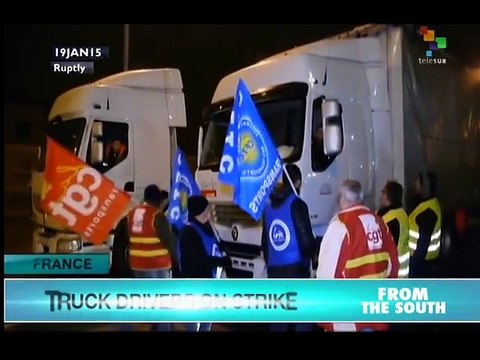French truck drivers strike, blocking roads to demand higher pay
