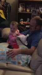Baby plays peek-a-boo with her dad