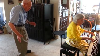 Elderly couple dance and play piano