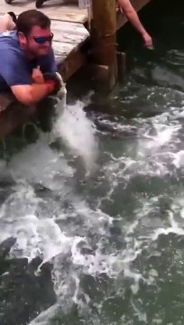 Fish vs dumb guy : fish catches entire arm of the man!