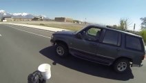 Motorcyclist Grabs Coffee Mug From Back Bumper Of Passing SUV