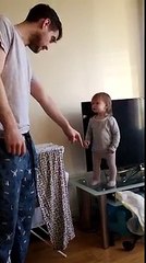 Bebê discute com o pai porque não quer sair de cima da mesa