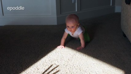 Adorable baby is startled by shadow