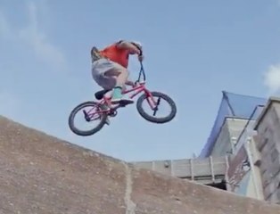 BMX rider jumps in the water