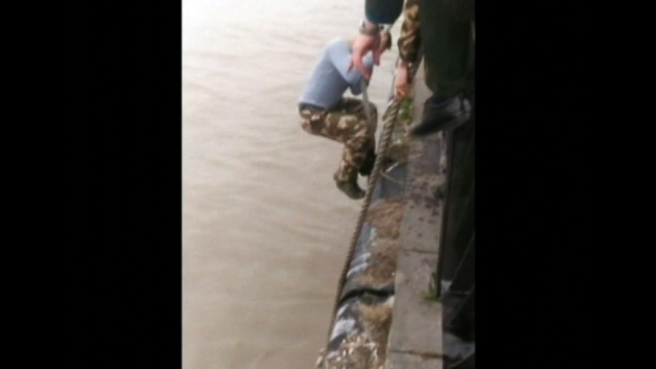 Soldiers rescue woman who jumped into river