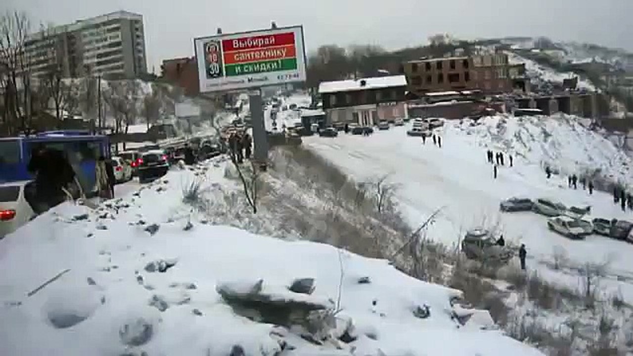 driving down icy hill road gathers cheery spectators