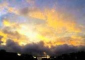 Cloud Formations Roll by in Sunset Timelapse Footage