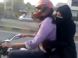 Boy Wheeling On Bike With Girl-