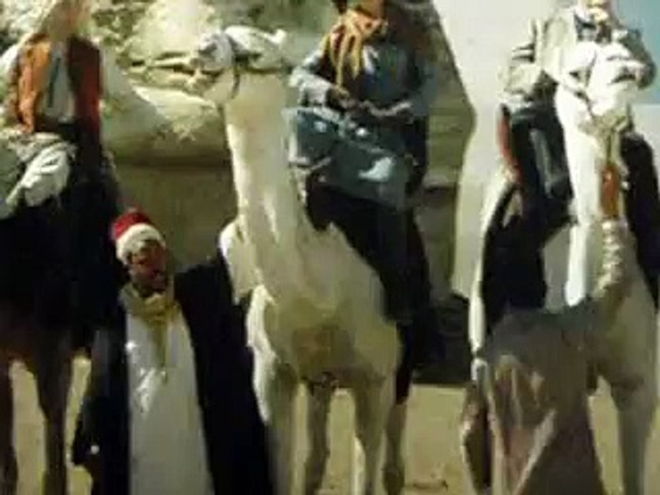 Rob Pattinson riding a camel