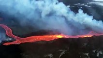 Plane flies over Iceland volcano spewing lava