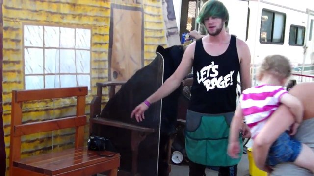 People getting picture taken with tame black bear