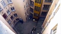 Throwing bucket of paper plane out of a building look pretty cool