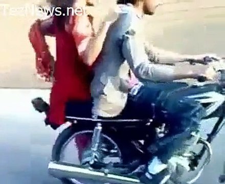 Pakistani Boy Performing One Wheeling with A Girl Sitting on Bike